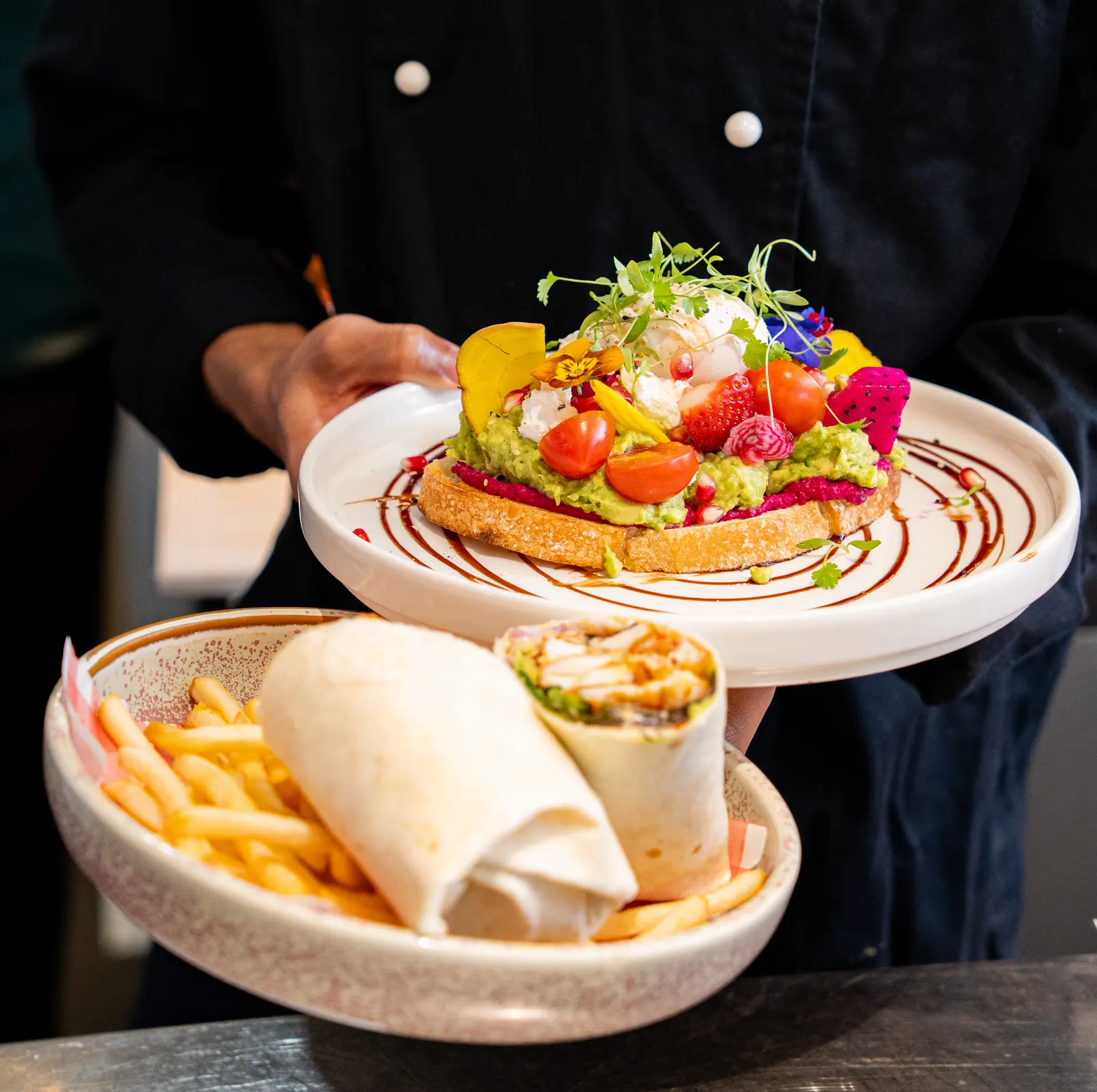 Chef presenting dishes at Bud Cafe